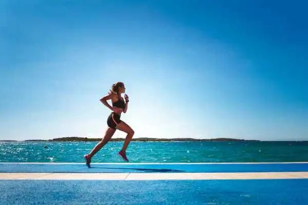 Woman running showing strong leg muscle Brentford